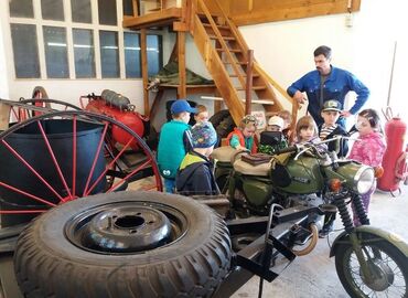 In das Kinder- und Jugendausbildungszentrum in Döbern ist auch ein kleines Feuerwehrmuseum integriert. Vor allem die einfache und mechanisch orientierte Technik ermöglicht es, den Kindern und Jugendlichen die Funktionsweise der Gerätschaften und Fahrzeuge einfach zu veranschaulichen.
Hier führt Kamerad Pult die Kinder der Kita Wirbelwind durch den Fuhrpark und erläutert die Aufgaben und Ausstattung eines KRAD