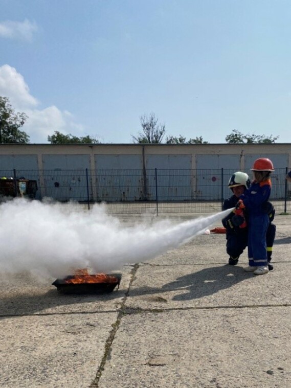 Löschen eines Feuers mit einem Pulverhandfeuerlöscher